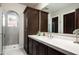 Stylish bathroom featuring a walk-in shower, marble countertop, and a well-lit vanity area at 20299 N 102Nd Pl, Scottsdale, AZ 85255