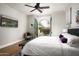 Bright bedroom with hardwood floors, TV, and balcony offering views of lush bougainvillea at 20299 N 102Nd Pl, Scottsdale, AZ 85255