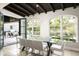 Elegant dining room with a modern chandelier and views of the beautiful backyard and outdoor kitchen at 20299 N 102Nd Pl, Scottsdale, AZ 85255