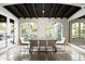 Bright dining room with travertine floors, wood beam ceilings, and large windows with backyard views at 20299 N 102Nd Pl, Scottsdale, AZ 85255