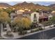 Stunning Mediterranean-style home featuring a red tile roof and lush landscaping at 20299 N 102Nd Pl, Scottsdale, AZ 85255