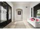 Bright foyer with tile floors, high ceilings, black iron front doors, and a stylish seating area at 20299 N 102Nd Pl, Scottsdale, AZ 85255