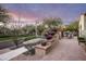 Paver walkway to a home with blooming flowers, potted plants, and manicured landscaping along the path at 20299 N 102Nd Pl, Scottsdale, AZ 85255