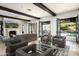 Open-concept living room with beamed ceilings, fireplace, and seamless indoor-outdoor flow to the backyard at 20299 N 102Nd Pl, Scottsdale, AZ 85255