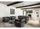 Modern living room featuring travertine floors, a fireplace, wood beams, and an open floor plan at 20299 N 102Nd Pl, Scottsdale, AZ 85255