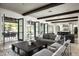 Bright living room featuring travertine floors, wood beams, and French doors leading to the backyard at 20299 N 102Nd Pl, Scottsdale, AZ 85255