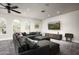 Spacious living room featuring large arched windows, recessed lighting, and a comfortable sectional sofa at 20299 N 102Nd Pl, Scottsdale, AZ 85255