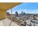 Balcony view of city skyline, parking, and street with white railing and yellow awning at 207 W Clarendon Ave # H10, Phoenix, AZ 85013