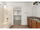 Bathroom featuring a shower-tub combo, vanity with granite counters, and walk-in closet at 21397 N Goles Dr, Maricopa, AZ 85138