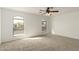 Spacious bedroom illuminated by natural light through two windows and a ceiling fan at 21397 N Goles Dr, Maricopa, AZ 85138