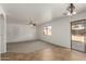 Open living room with tile and carpet, featuring a sliding glass door and neutral tones at 21397 N Goles Dr, Maricopa, AZ 85138