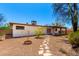 Backyard view features desert landscaping, covered patio, and block fencing at 2142 E Palmcroft Dr, Tempe, AZ 85282