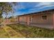 Backyard with covered patio perfect for relaxing and grass that is newly planted at 2142 E Palmcroft Dr, Tempe, AZ 85282