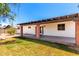View of covered patio area with brick columns, concrete flooring, and minimal grass at 2142 E Palmcroft Dr, Tempe, AZ 85282