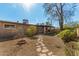 Backyard patio with stone walkway surrounded by plants and trees provides outdoor living space at 2142 E Palmcroft Dr, Tempe, AZ 85282