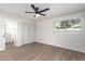 Bright bedroom featuring wood-look flooring, a ceiling fan, and closet with sliding doors at 2142 E Palmcroft Dr, Tempe, AZ 85282