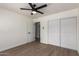 This bedroom features hardwood flooring, a ceiling fan, and lots of closet space at 2142 E Palmcroft Dr, Tempe, AZ 85282