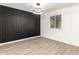 Minimalist bedroom with wood-look flooring, a modern accent wall and ample natural light at 2142 E Palmcroft Dr, Tempe, AZ 85282