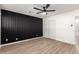 This bedroom offers a unique accent wall, light hardwood flooring, and a ceiling fan at 2142 E Palmcroft Dr, Tempe, AZ 85282