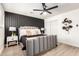 Serene bedroom with neutral tones, wood-look floors, and stylish accent wall creates a relaxing retreat at 2142 E Palmcroft Dr, Tempe, AZ 85282