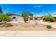 Charming home exterior with white stucco, brown trim, desert landscaping and a winding driveway at 2142 E Palmcroft Dr, Tempe, AZ 85282