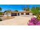 Single-story home showcasing a desert-style front yard with a winding driveway and attached garage at 2142 E Palmcroft Dr, Tempe, AZ 85282