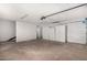 Spacious garage with storage cabinets and overhead lighting at 2142 E Palmcroft Dr, Tempe, AZ 85282