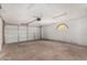 Spacious garage with painted walls, overhead lighting, and steel door at 2142 E Palmcroft Dr, Tempe, AZ 85282