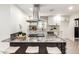 Bright kitchen features white cabinetry, stainless steel appliances, granite countertops, and an island with seating at 2142 E Palmcroft Dr, Tempe, AZ 85282