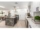 Bright kitchen features white cabinetry, stainless steel appliances, granite countertops, and an island with seating at 2142 E Palmcroft Dr, Tempe, AZ 85282