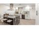 Bright kitchen features white cabinetry, stainless steel appliances, granite countertops, and an island with seating at 2142 E Palmcroft Dr, Tempe, AZ 85282
