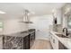 Bright kitchen features stone countertops, island with cooktop, stainless hood and appliances, and a pass-through window at 2142 E Palmcroft Dr, Tempe, AZ 85282