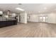 Spacious living room with wood-look flooring, leading into the modern, updated kitchen at 2142 E Palmcroft Dr, Tempe, AZ 85282