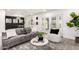 Comfortable living room featuring stylish decor, plush seating, and access to the outdoor space through French doors at 2142 E Palmcroft Dr, Tempe, AZ 85282