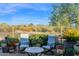 Inviting backyard patio with comfortable seating, potted plants, and a view of the desert landscape at 22211 N 51St St, Phoenix, AZ 85054