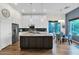 Modern kitchen featuring an island with granite countertops, stainless steel appliances, and white cabinetry at 22211 N 51St St, Phoenix, AZ 85054