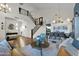 Open-concept living room featuring vaulted ceilings, hardwood floors, staircase and an adjacent dining area at 22211 N 51St St, Phoenix, AZ 85054