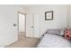 Cozy bedroom featuring a neutral carpet and doorway to another room at 22288 S 214Th S St, Queen Creek, AZ 85142