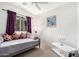 Bright bedroom featuring a daybed, white walls, and neutral carpeting at 22288 S 214Th S St, Queen Creek, AZ 85142