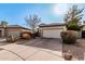 Charming home with desert landscaping and an attached two-car garage at 22288 S 214Th S St, Queen Creek, AZ 85142