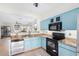 The bright kitchen features blue cabinets, a stainless steel dishwasher, and an oven at 22288 S 214Th S St, Queen Creek, AZ 85142