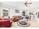 Bright living room with tile flooring, ceiling fan, and view to kitchen at 22288 S 214Th S St, Queen Creek, AZ 85142