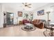 Bright living room with tile flooring, ceiling fan, and natural light at 22288 S 214Th S St, Queen Creek, AZ 85142