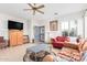 Bright living room with tile flooring, ceiling fan, and view to front entry at 22288 S 214Th S St, Queen Creek, AZ 85142