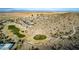 Aerial view of golf course and community surrounded by desert landscape at 227 W Lantern Way, San Tan Valley, AZ 85143