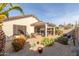 Beautiful backyard showcasing a covered patio, desert landscaping, and comfortable outdoor seating at 227 W Lantern Way, San Tan Valley, AZ 85143