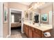 Bathroom showcasing double sinks, wood cabinetry, and view to the bedroom at 227 W Lantern Way, San Tan Valley, AZ 85143