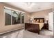 Spacious bedroom with a large window, ceiling fan, and carpeted floor at 227 W Lantern Way, San Tan Valley, AZ 85143