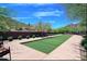 Manicured bocce ball court in a beautiful outdoor space with seating and desert landscaping at 227 W Lantern Way, San Tan Valley, AZ 85143