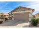 Well-kept home featuring low maintenance landscaping, neutral tones and a two-car garage at 227 W Lantern Way, San Tan Valley, AZ 85143